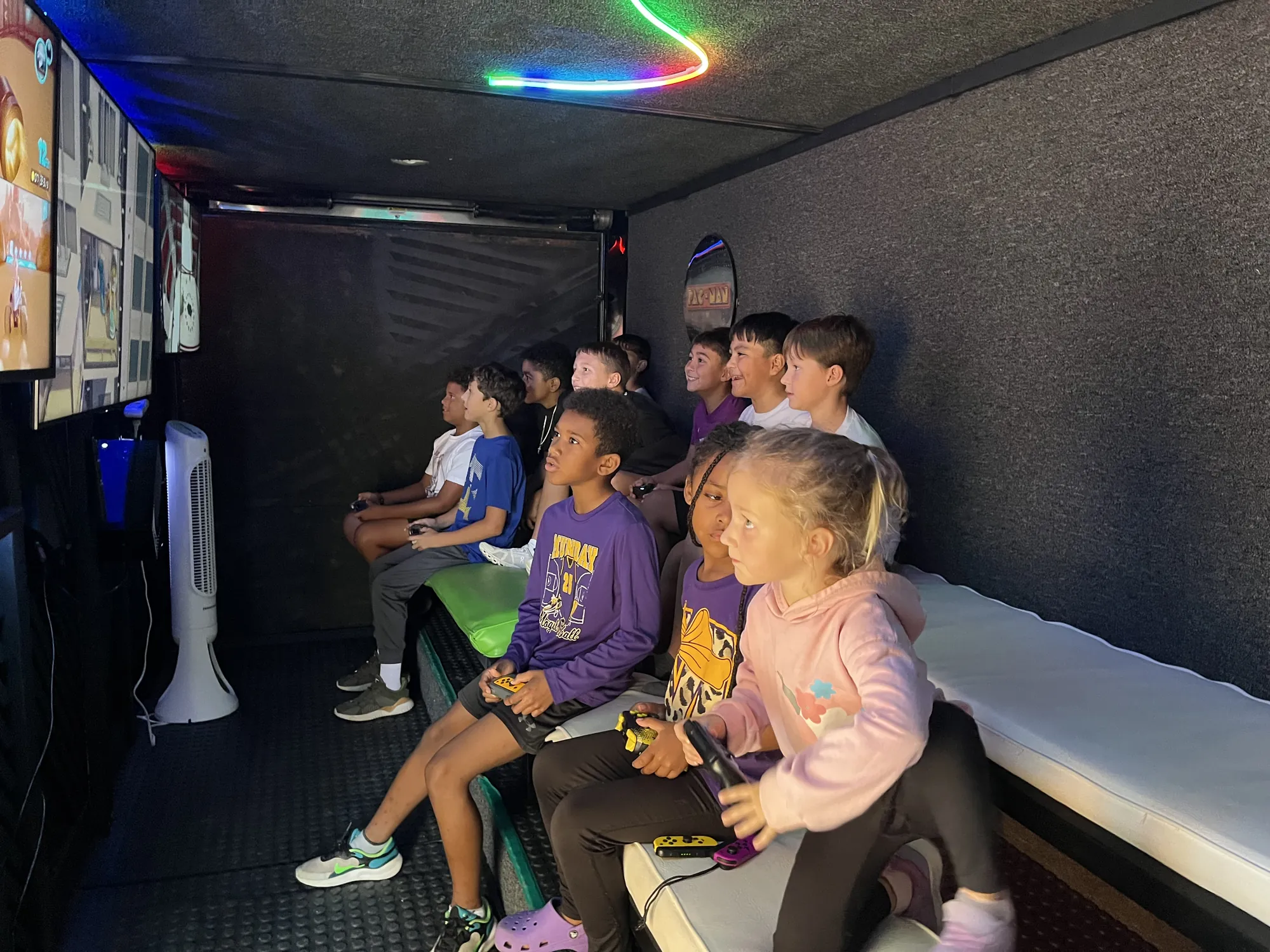 Younger kids playing side by side on the trailer’s big screens at a kids birthday party in Abilene, TX