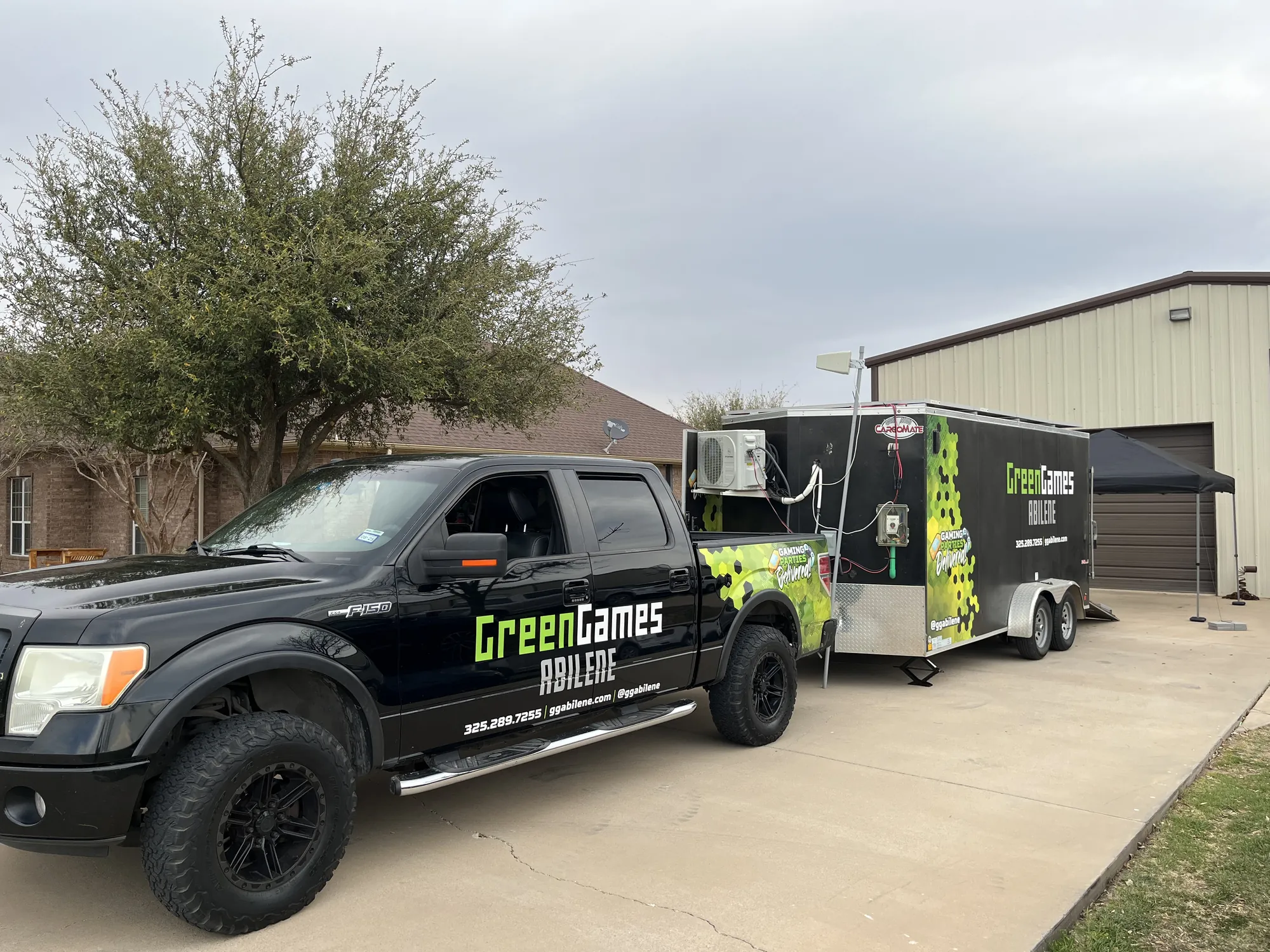The Green Games truck and video game trailer parked at a home in Abilene