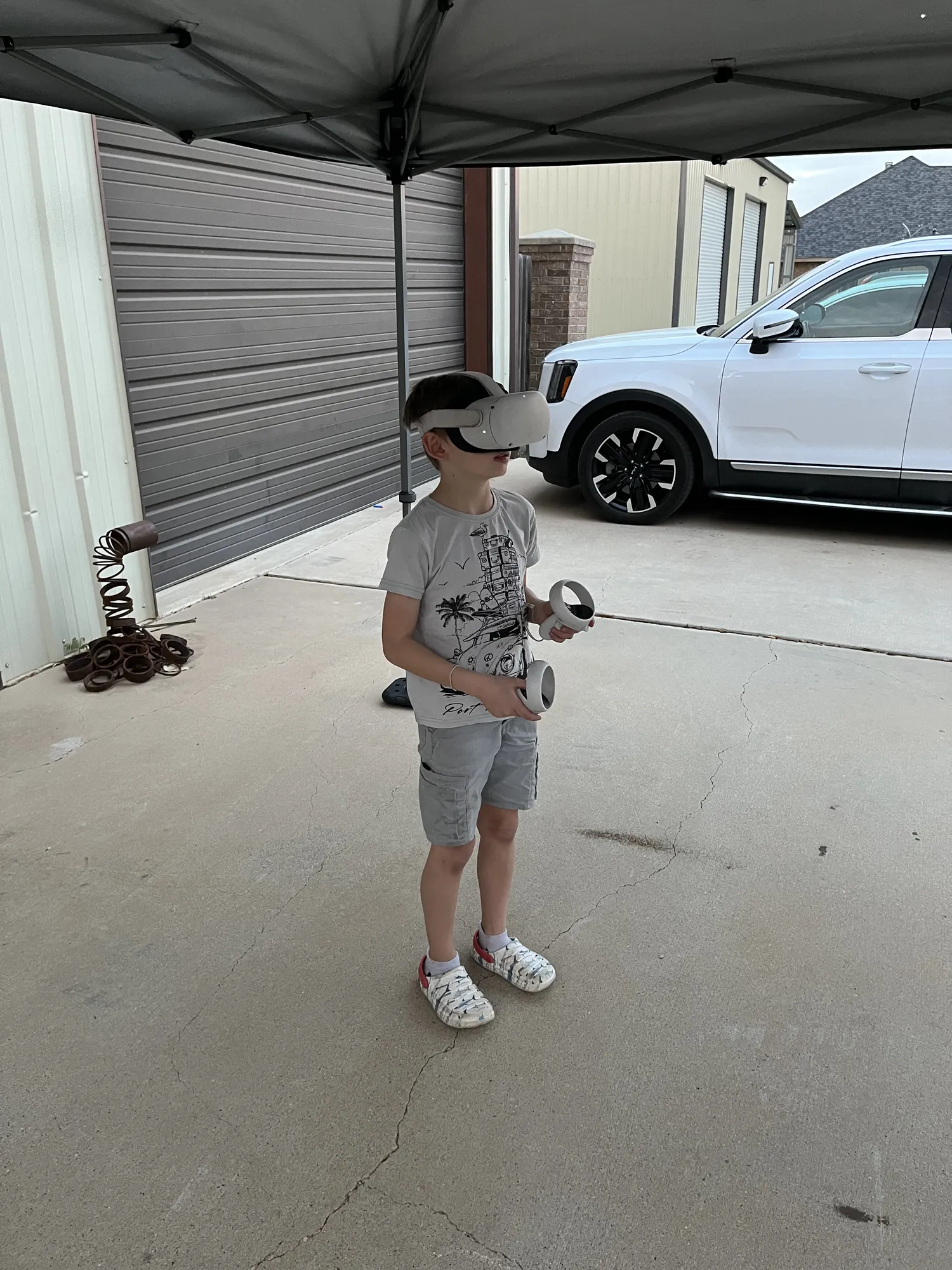 A boy trying a VR headset in a garage during a birthday party