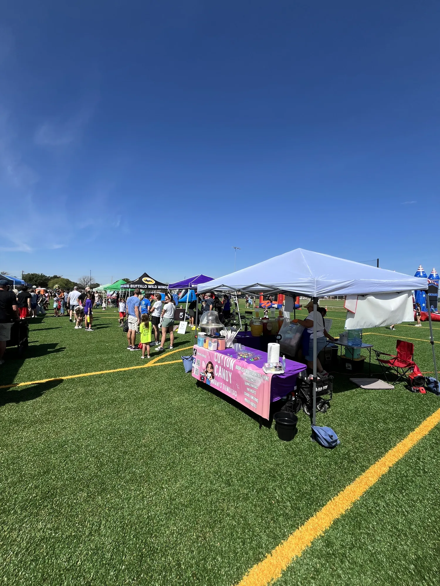 Vendor tents and families on the turf fields at the ROC soccer complex in Abilene