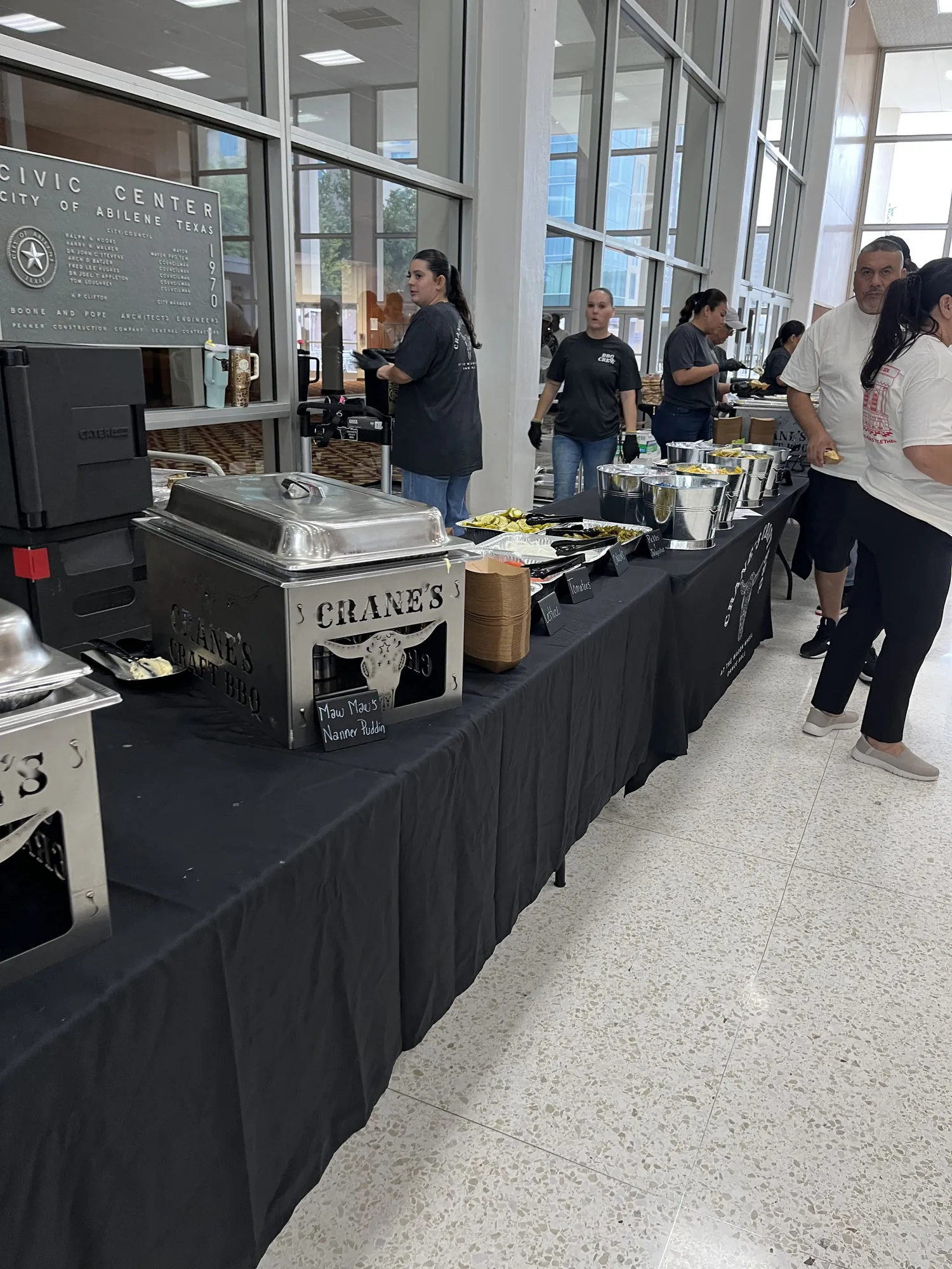 Employees lining up at a catered lunch buffet at an Abilene company family day
