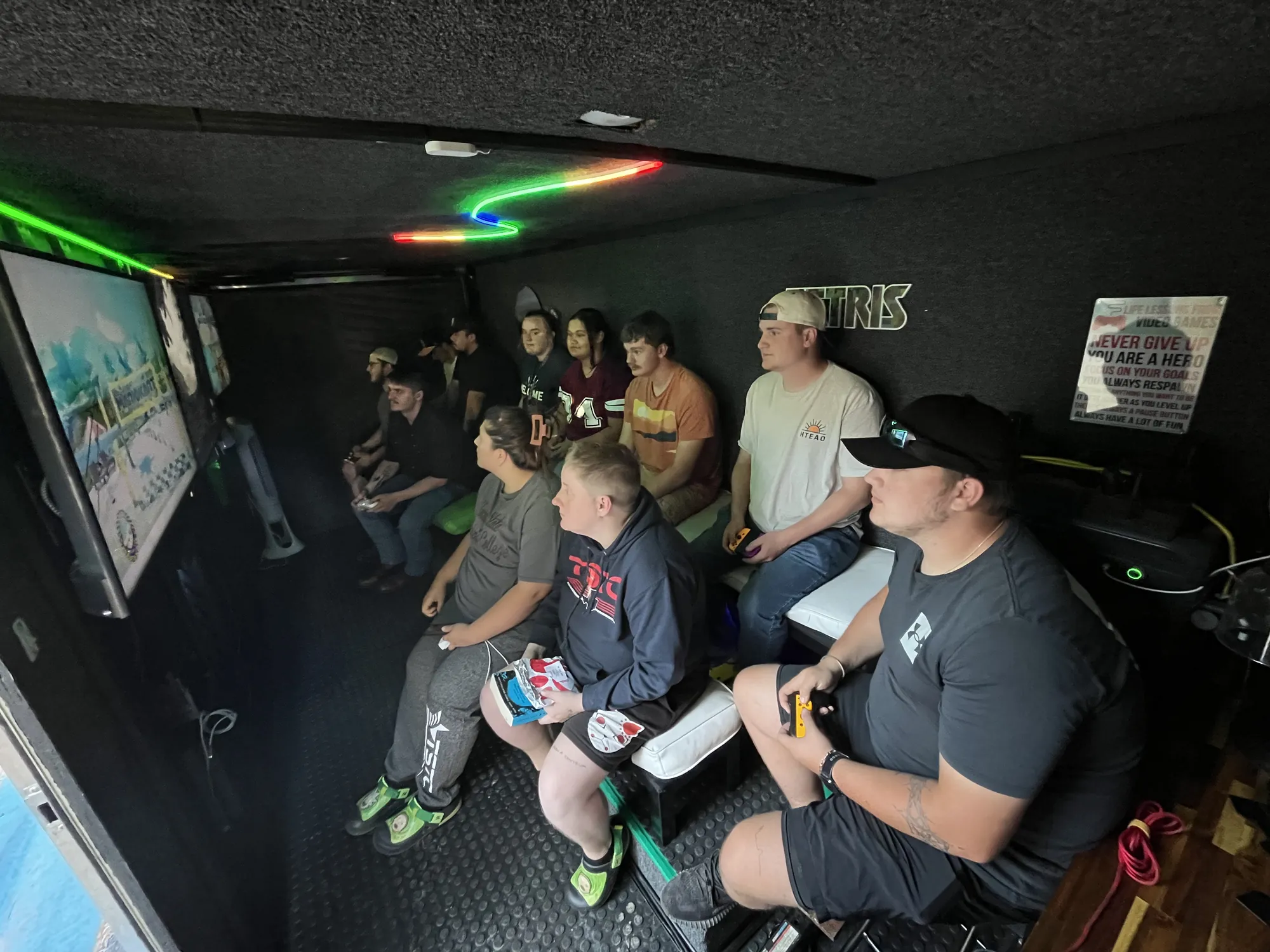 A full trailer of grown-ups and kids playing video games side by side at a corporate event in Abilene, TX