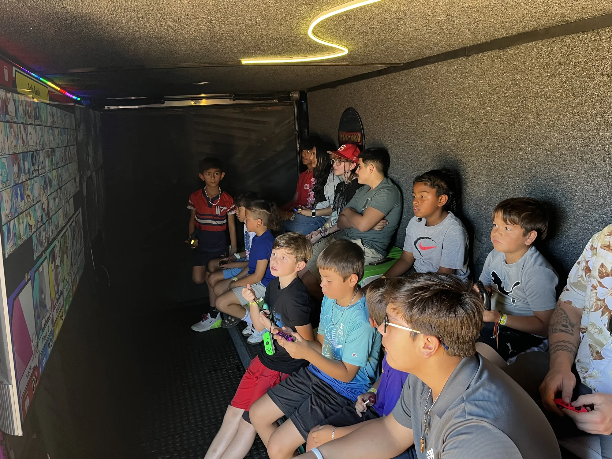 A full trailer of kids and teens playing video games together at a church fall festival