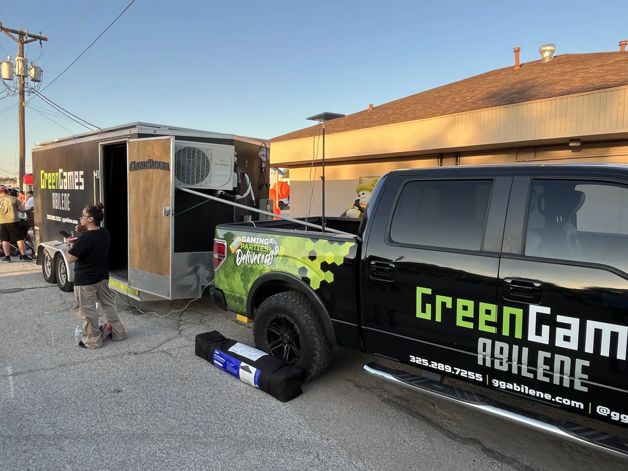 The Green Games truck and trailer parked beside the church at a fall festival