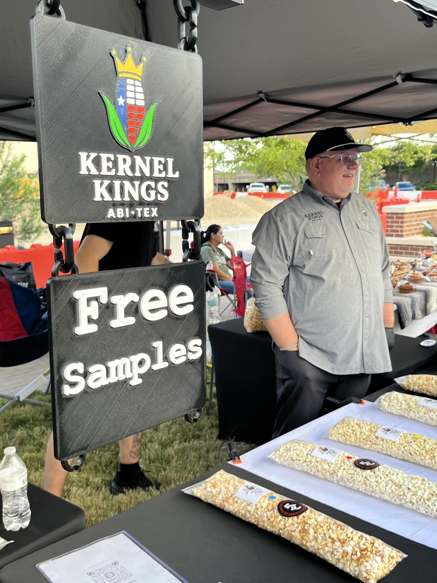 Kernel Kings booth with a Free Samples sign and bags of popcorn
