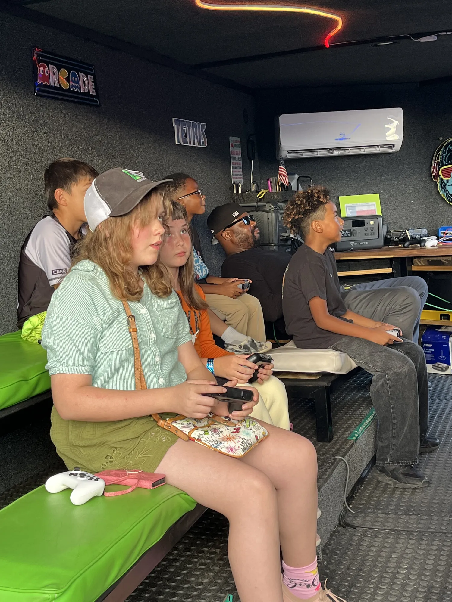 Kids focused on their controllers inside the trailer