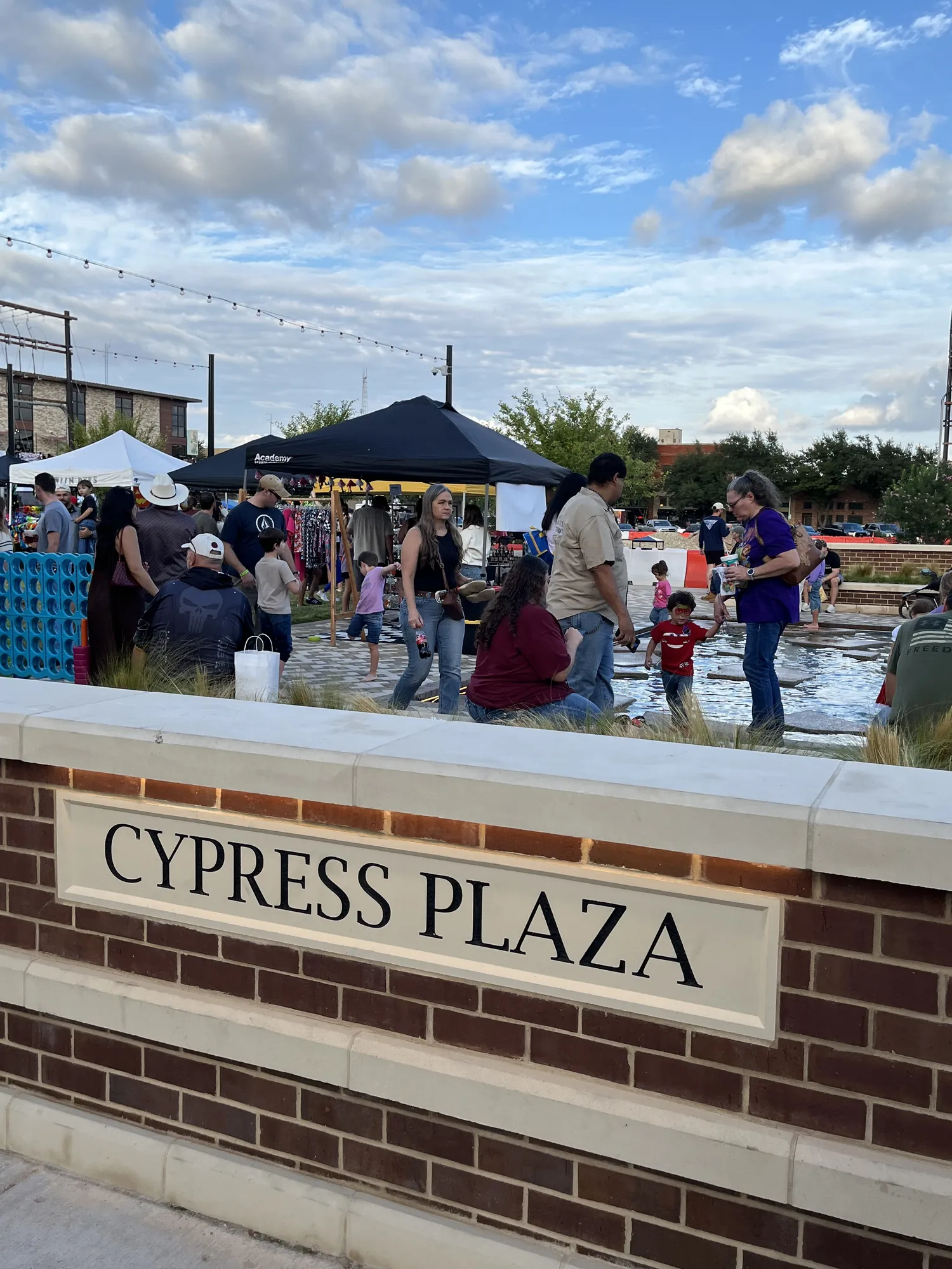 Families gathered around the Cypress Plaza sign during Downtown Oktoberfest