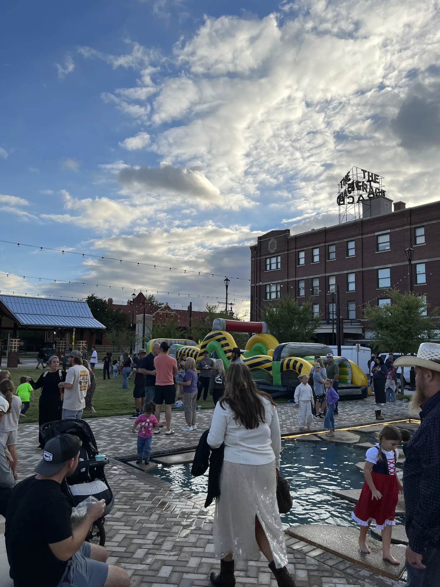 Cypress Plaza under a big sky, with the inflatable obstacle course in the distance