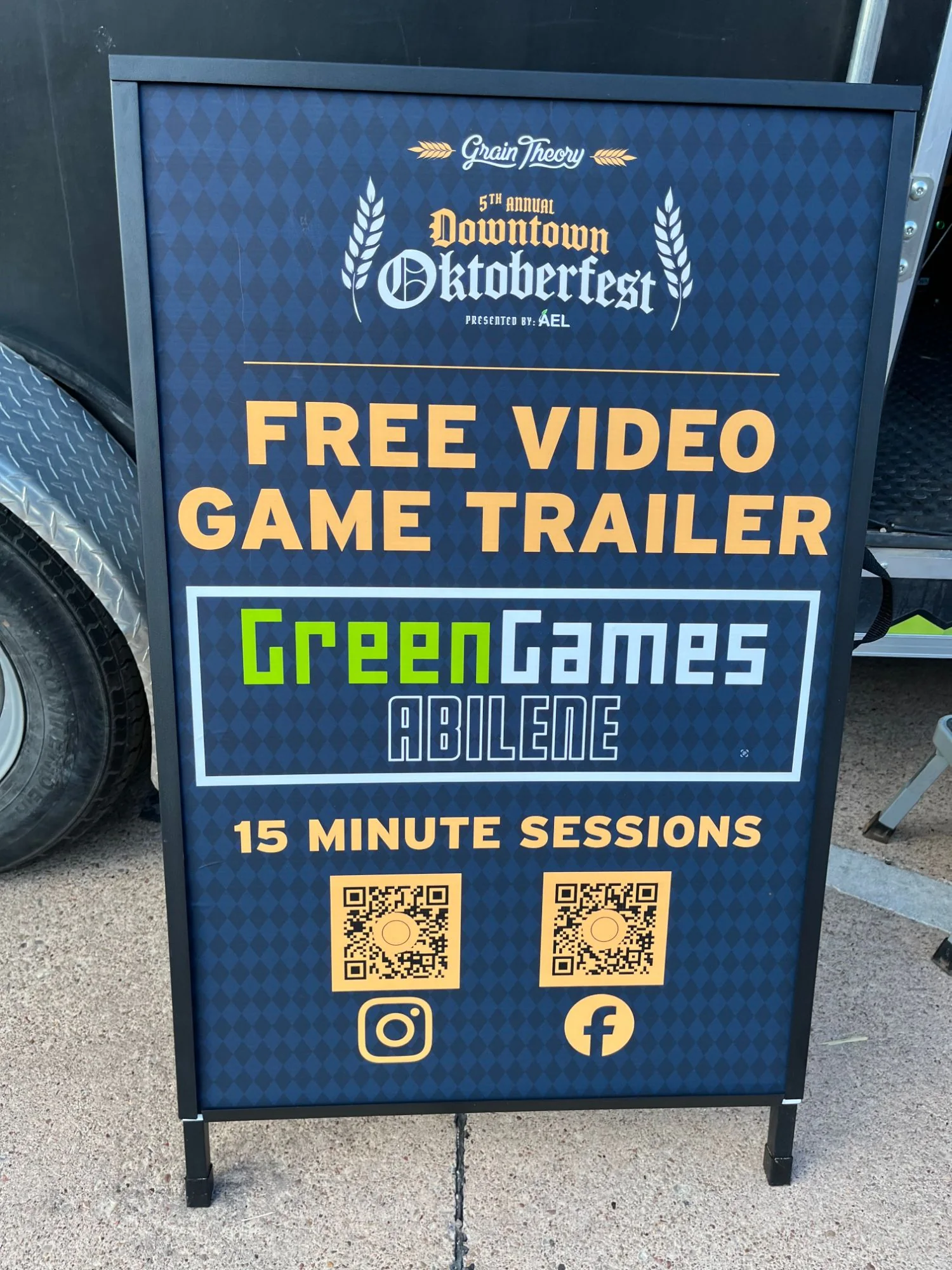 Oktoberfest sign reading “Free video game trailer, Green Games Abilene, 15 minute sessions”