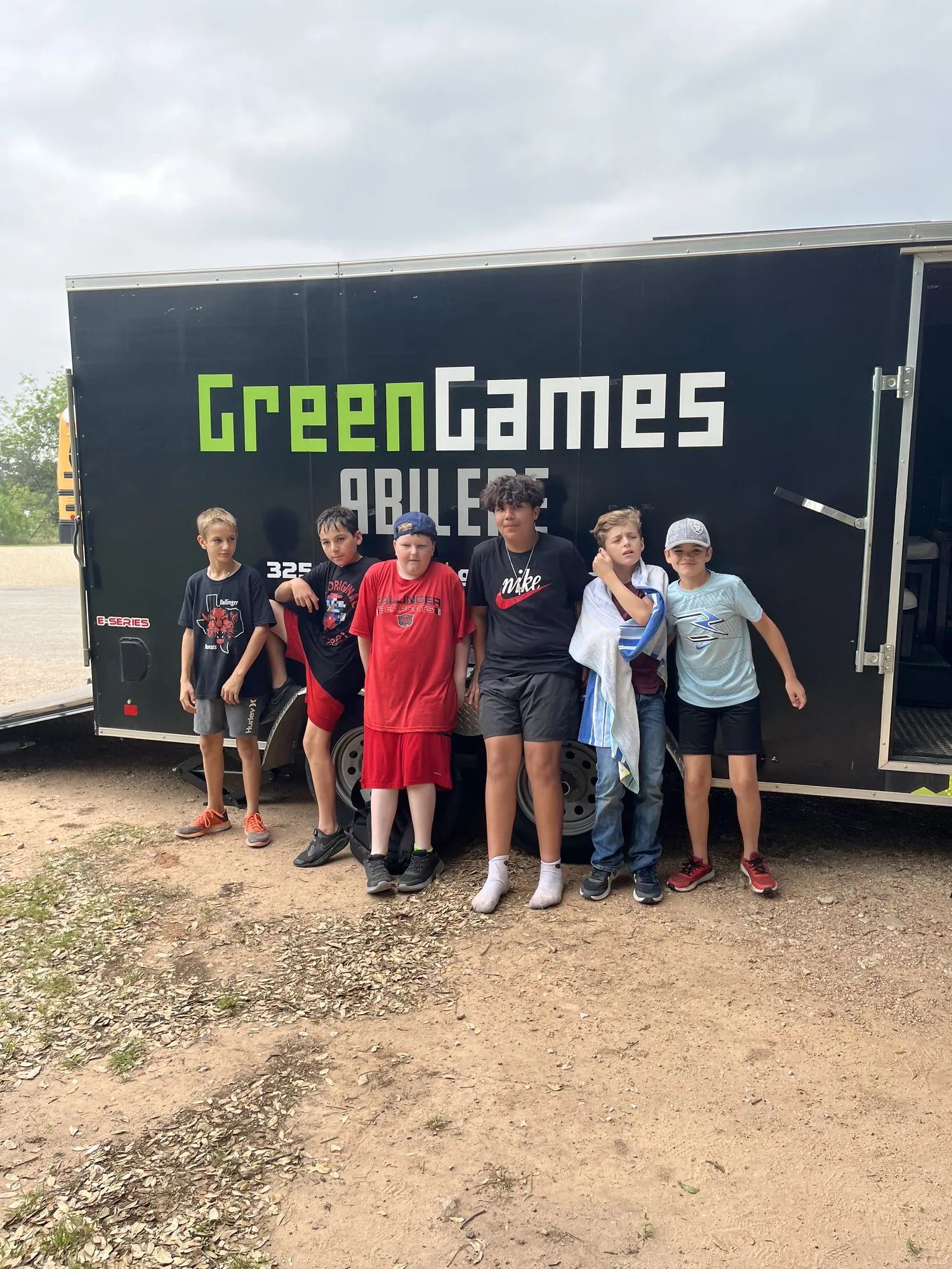A group of students posing in front of the Green Games Abilene trailer at a school field day in the Big Country