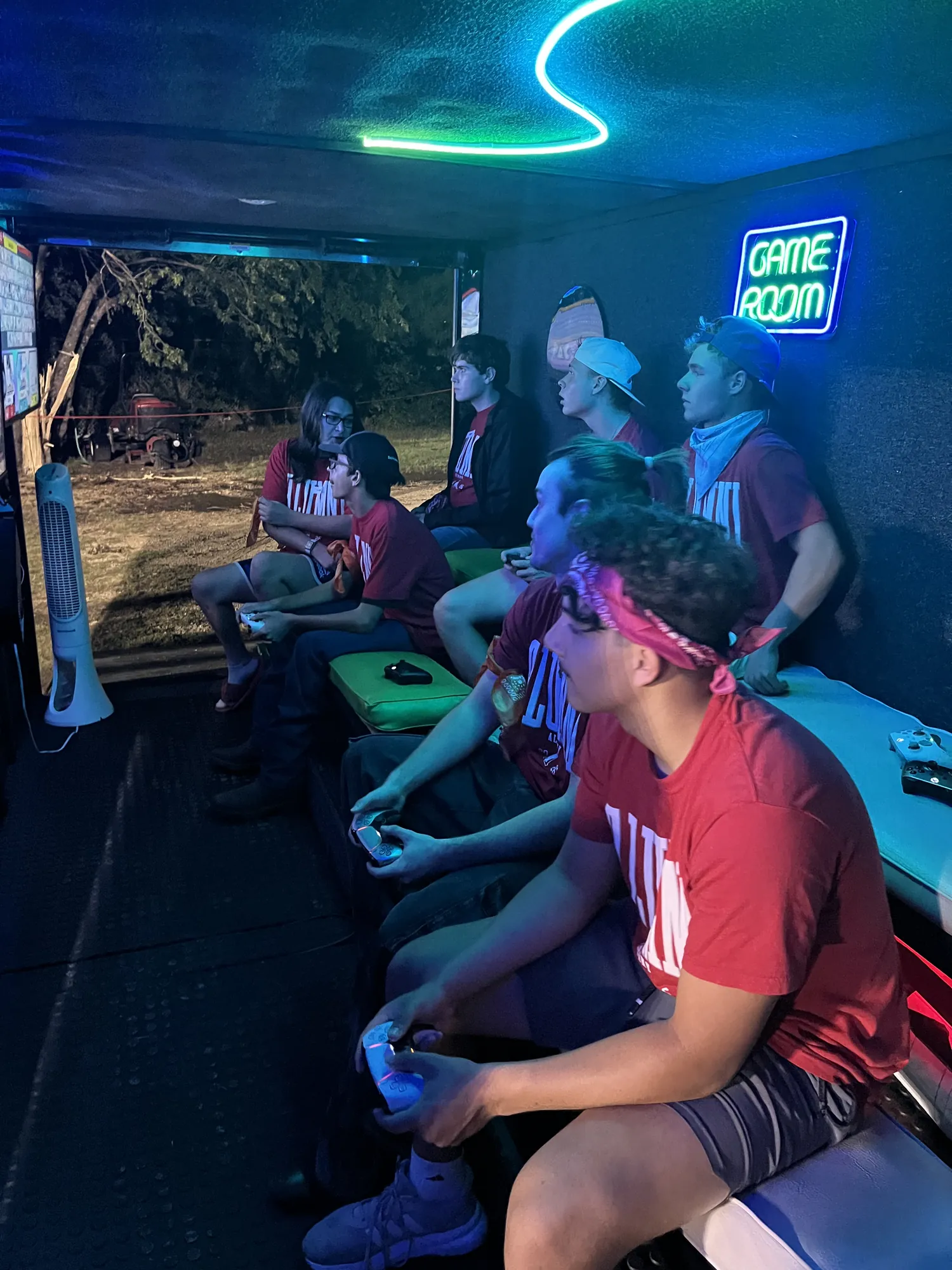 A full trailer of graduates holding controllers during a Project Graduation lock-in night in Texas
