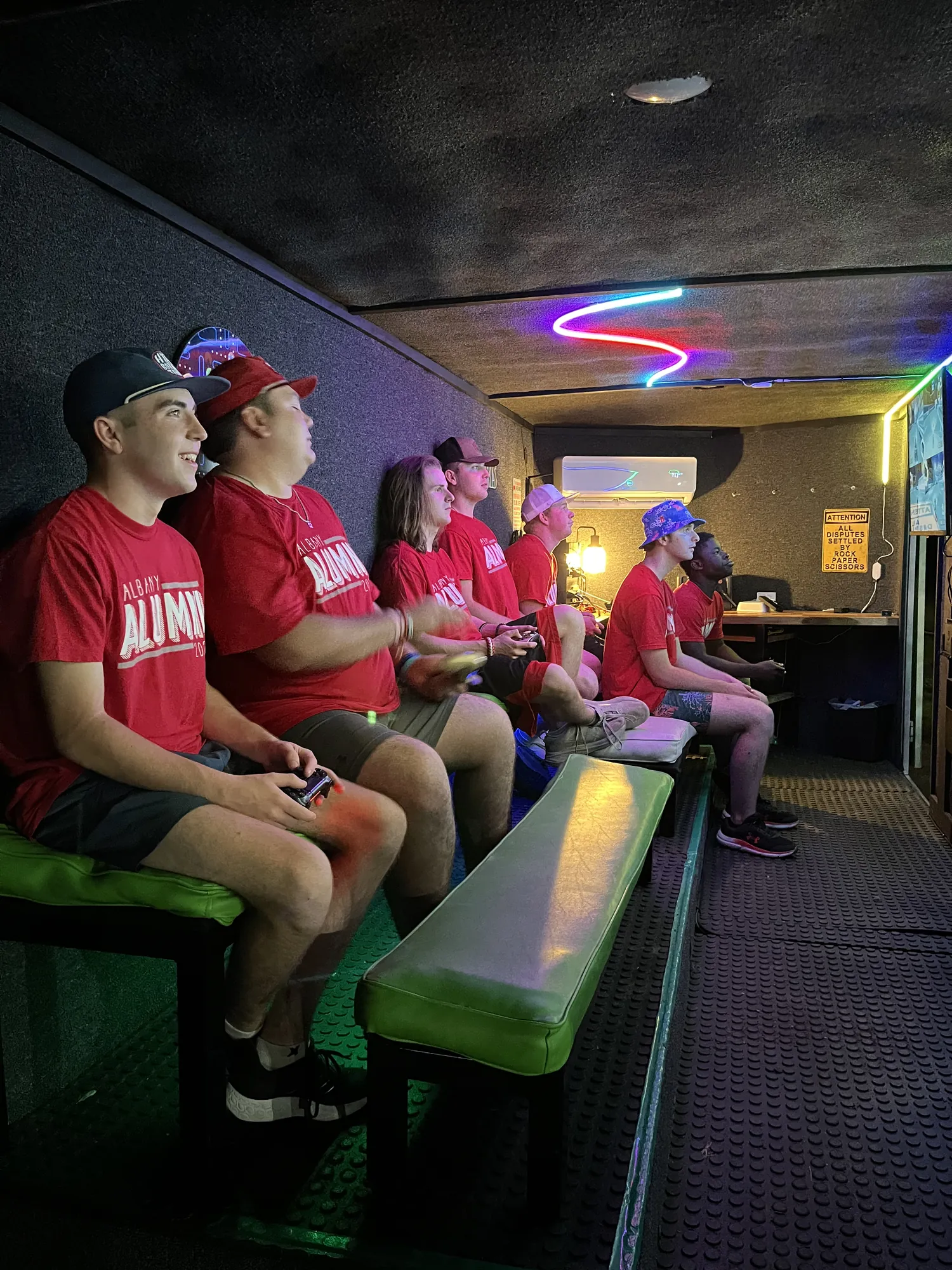 High school seniors playing video games side by side inside the Green Games trailer during an overnight Project Graduation in the Big Country