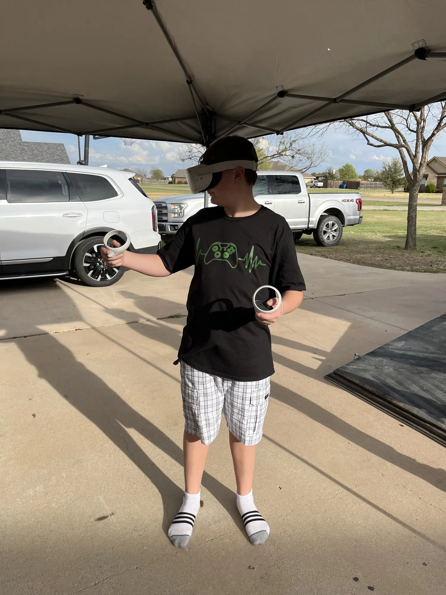 A player in a VR headset holding both controllers out in front of him