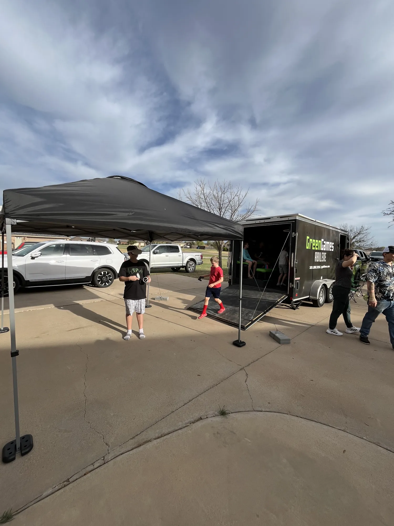 A VR player under our shade tent beside the Green Games trailer
